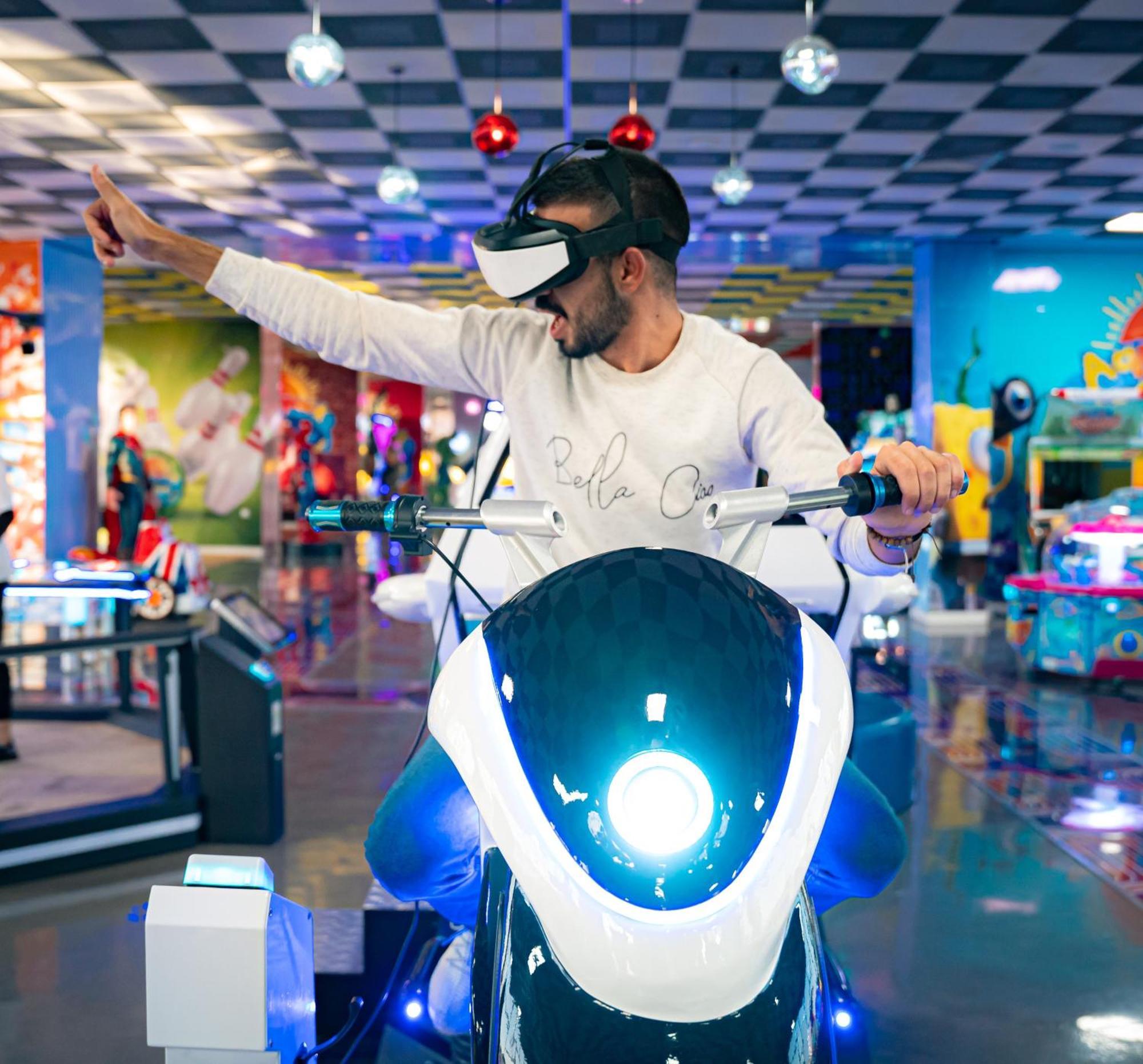 Waves Aqua Resort Кенитра Екстериор снимка A man playing a motorcycle racing game with a virtual reality headset